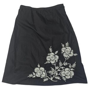 Classic Elements black A-line skirt featuring white floral embroidery